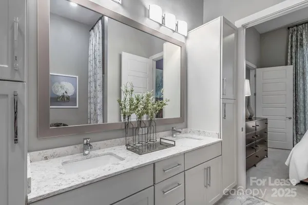 a bathroom with a glass shower door and a mirror
