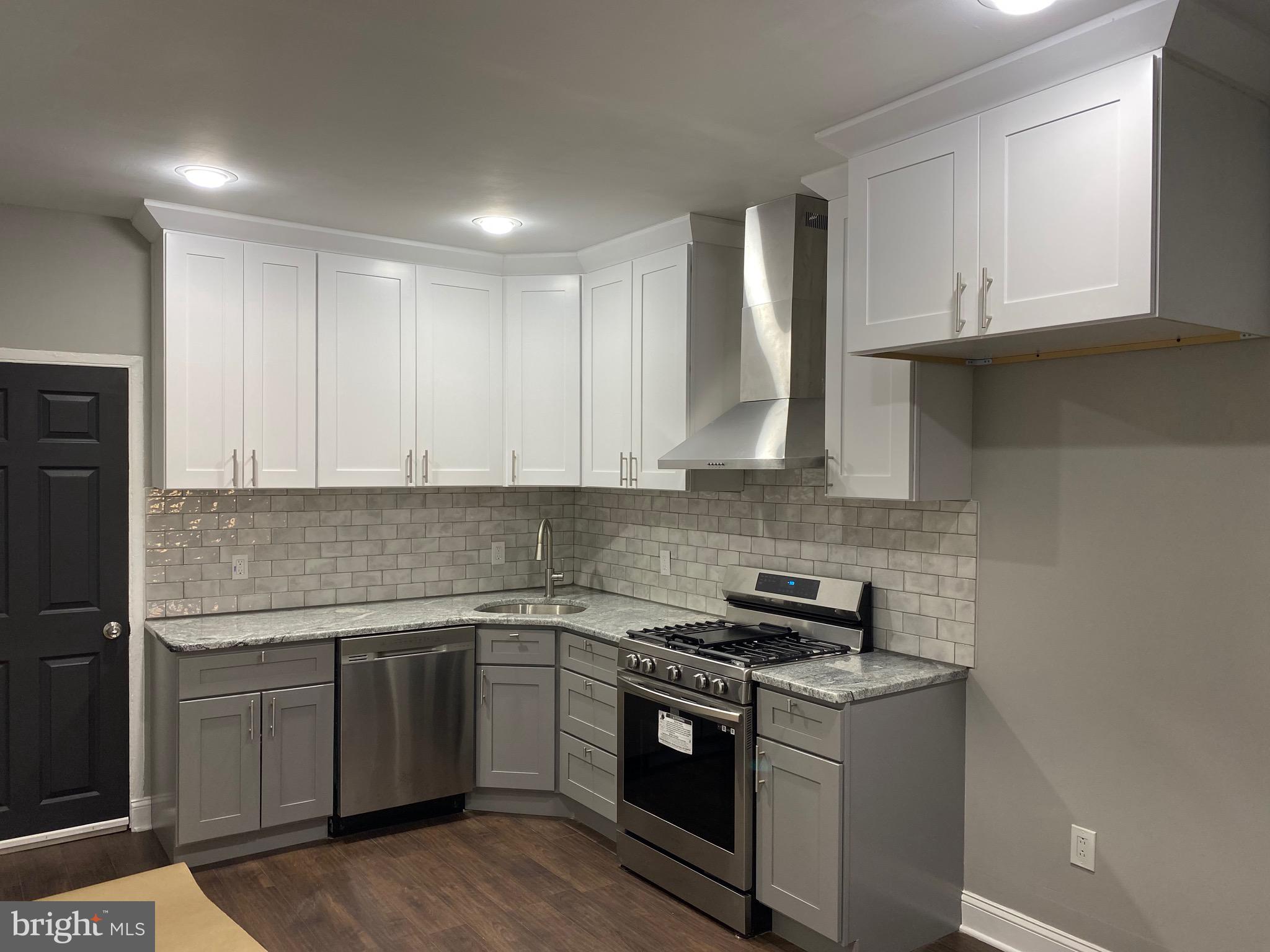 3167 East Thompson Street Philadelphia, PA 19134 - Photo 6 of 26 a kitchen with stainless steel appliances granite countertop a sink stove and refrigerator