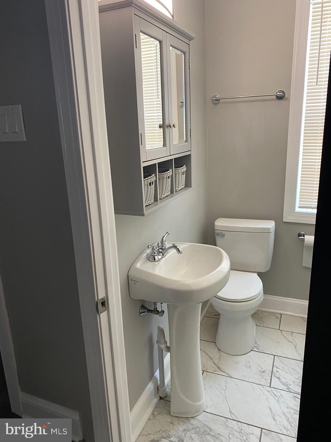 3167 East Thompson Street Philadelphia, PA 19134 - Photo 7 of 26 a bathroom with a sink a toilet and mirror