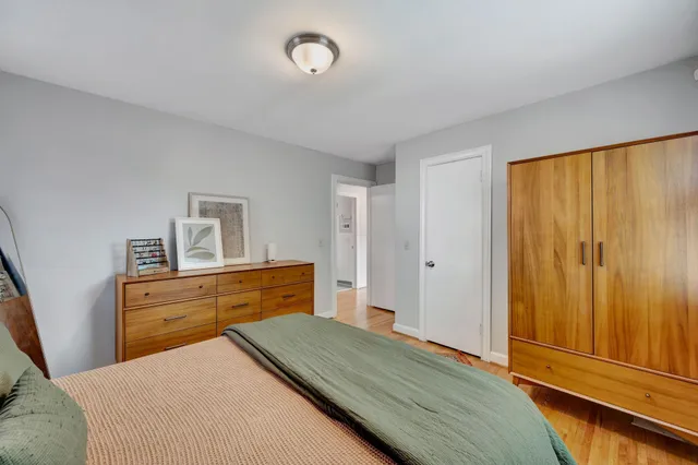 a bedroom with a bed and a dresser