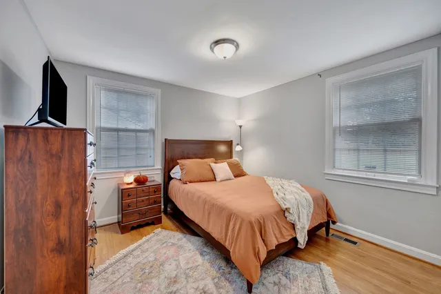 a bedroom with a bed and flat screen tv
