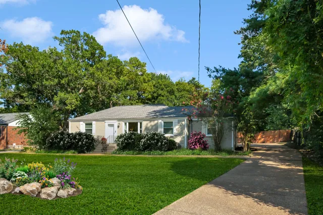 a view of a house with a backyard and garden