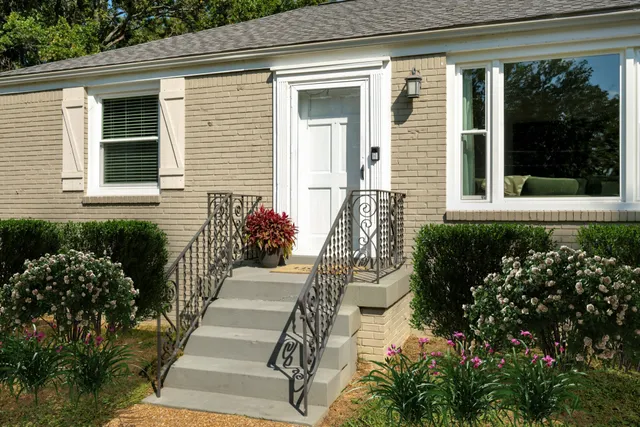 a front view of a house with a garden
