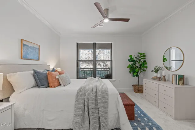 a bed room with a bed a potted plant and a window
