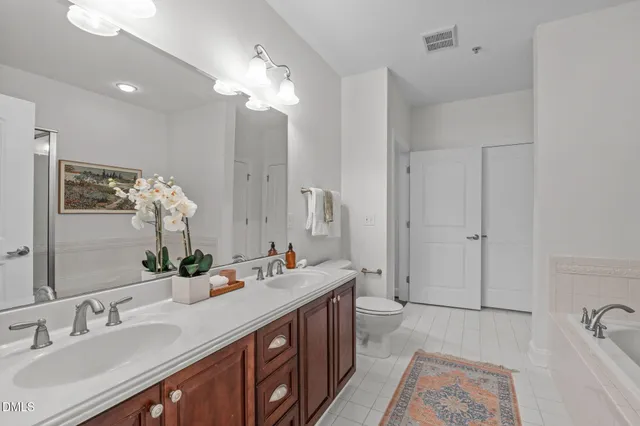a spacious bathroom with a double vanity sink mirror and double
