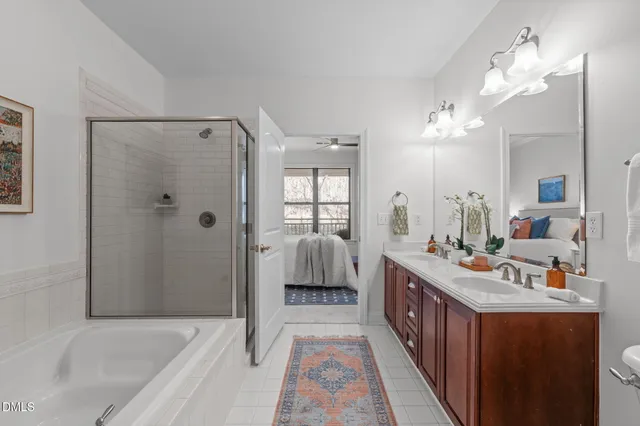 a bathroom with a tub sink shower and mirror