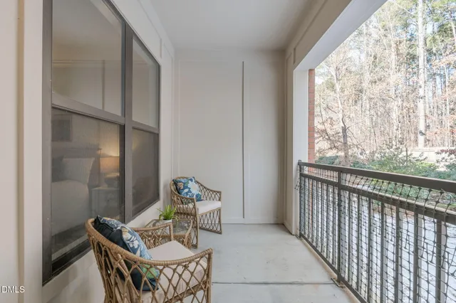 a view of a hallway with wooden floor and closet