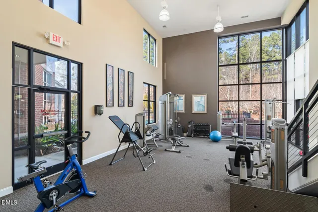 a room with gym equipment and windows