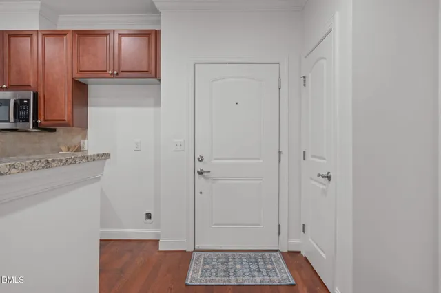 a view of walk in closet with wooden floor