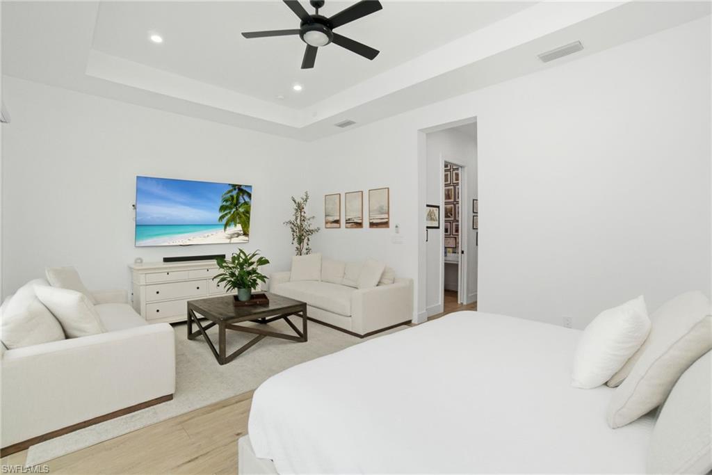 522 31st Street Southwest Naples, FL 34117 - Photo 19 of 38 Spacious room featuring a tray ceiling with recessed lighting and a black ceiling fan