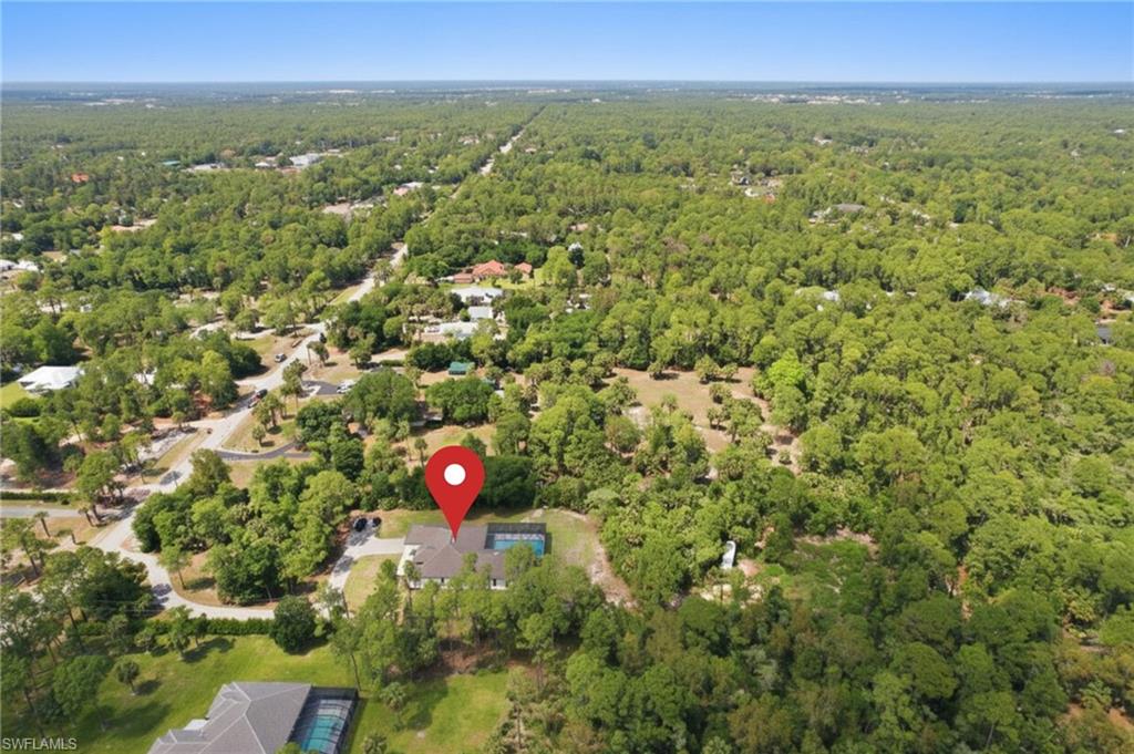 522 31st Street Southwest Naples, FL 34117 - Photo 4 of 38 Aerial view of a residential property surrounded by mature trees