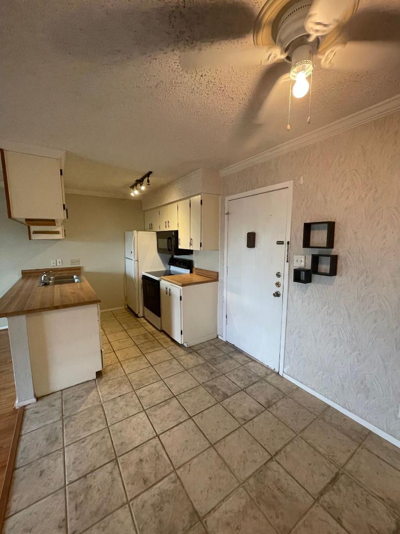 910 Duncan Lane, Unit 44 Austin, TX 78705 - Photo 2 of 15 Functional kitchen with ample cabinetry and essential appliances.