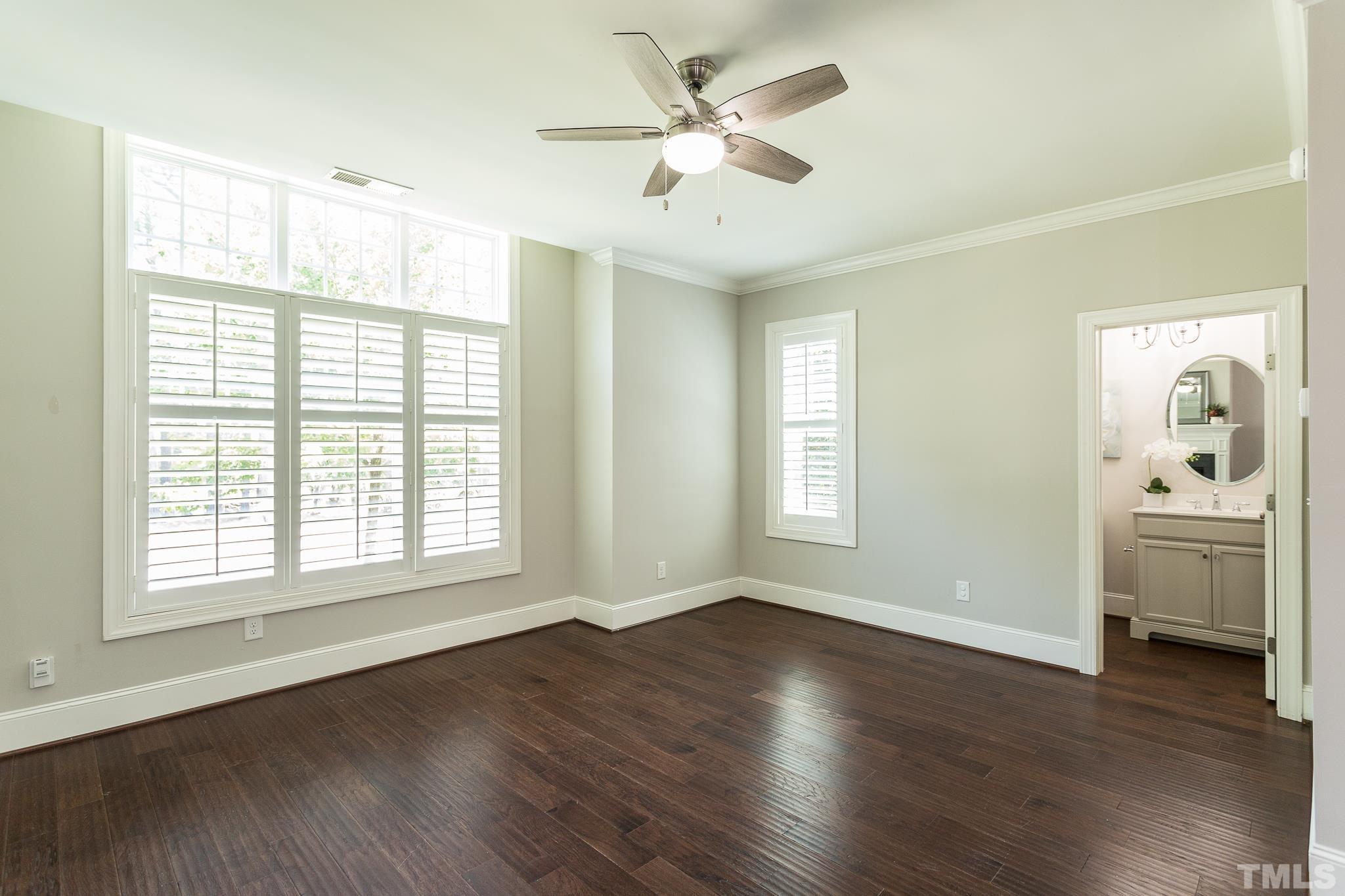 2824 Plumfield Place Raleigh, NC 27607 - Photo 11 of 21 a view of an empty room with a window and wooden floor