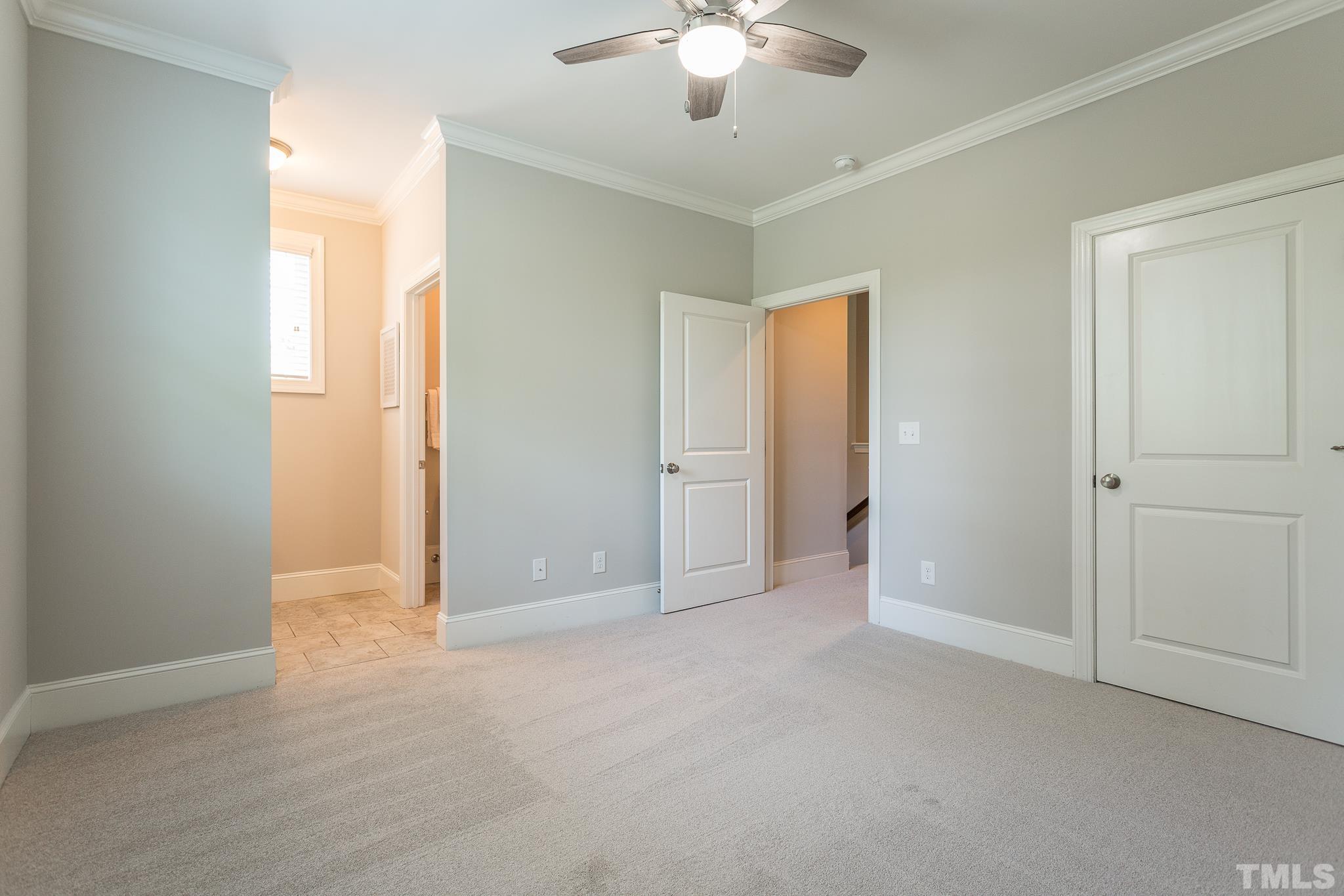 2824 Plumfield Place Raleigh, NC 27607 - Photo 14 of 21 a view of an empty room with a chandelier fan