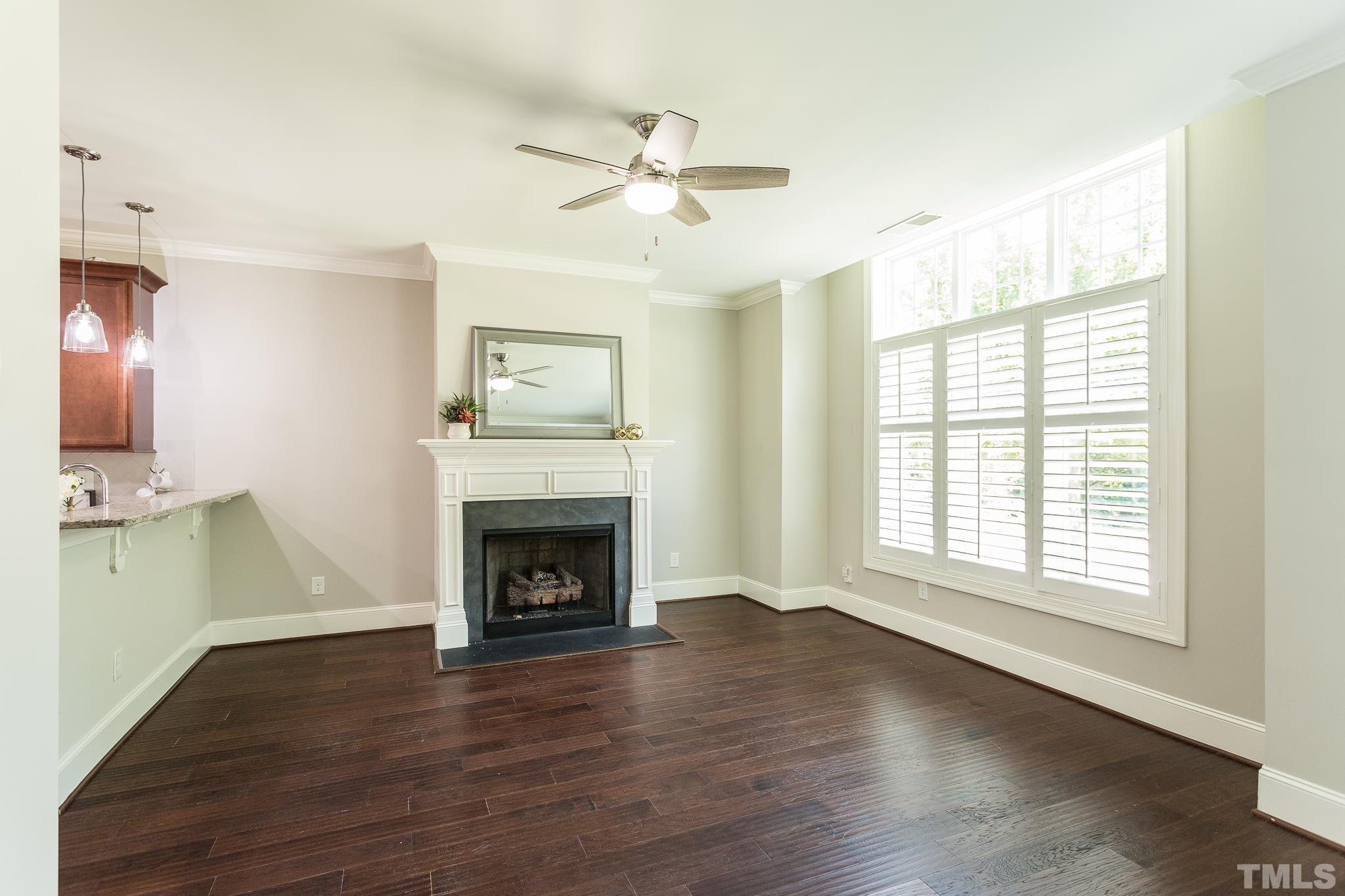 2824 Plumfield Place Raleigh, NC 27607 - Photo 3 of 21 a view of an empty room with wooden floor and a window