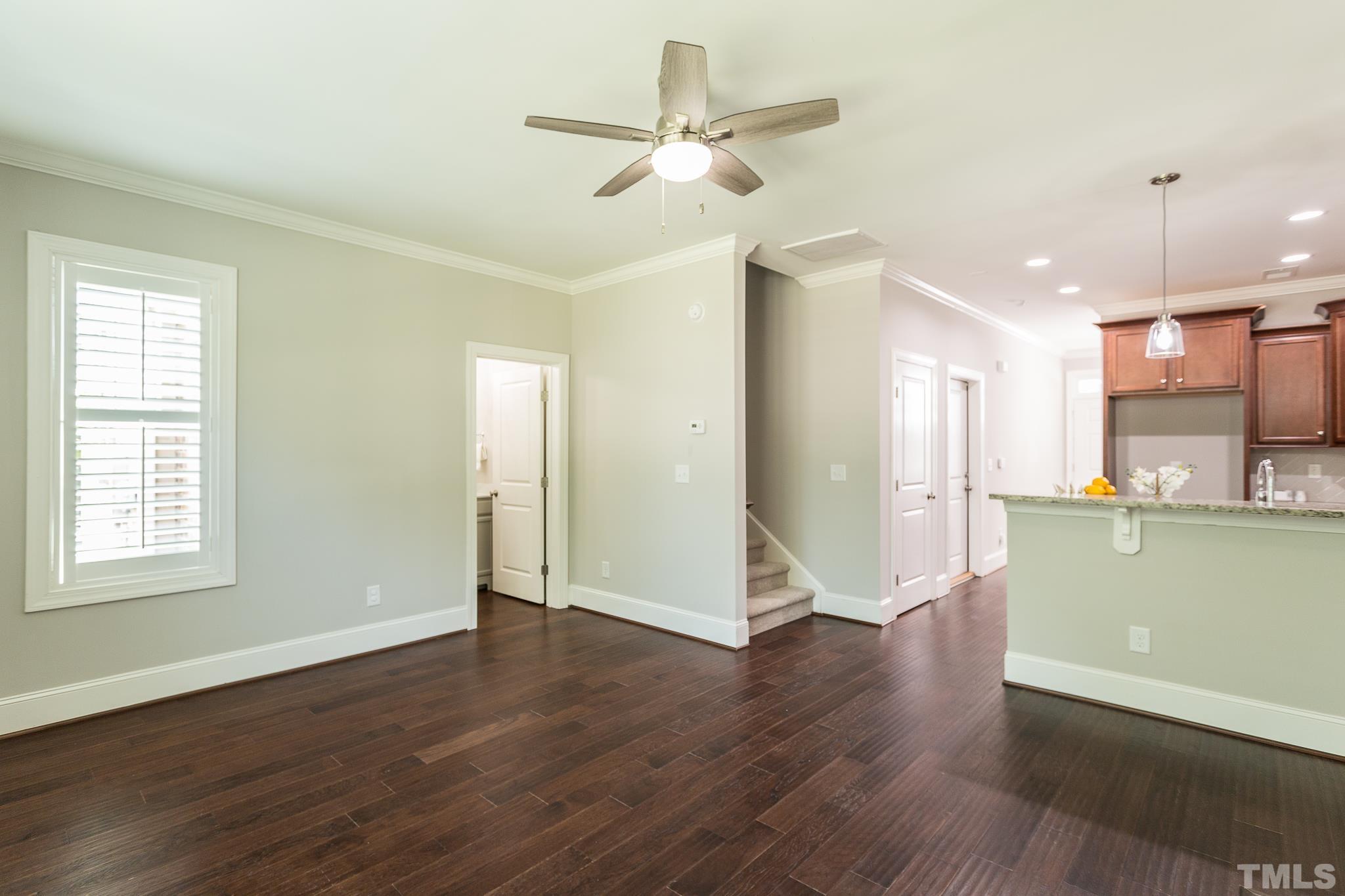 2824 Plumfield Place Raleigh, NC 27607 - Photo 4 of 21 a view of an empty room with wooden floor and a window