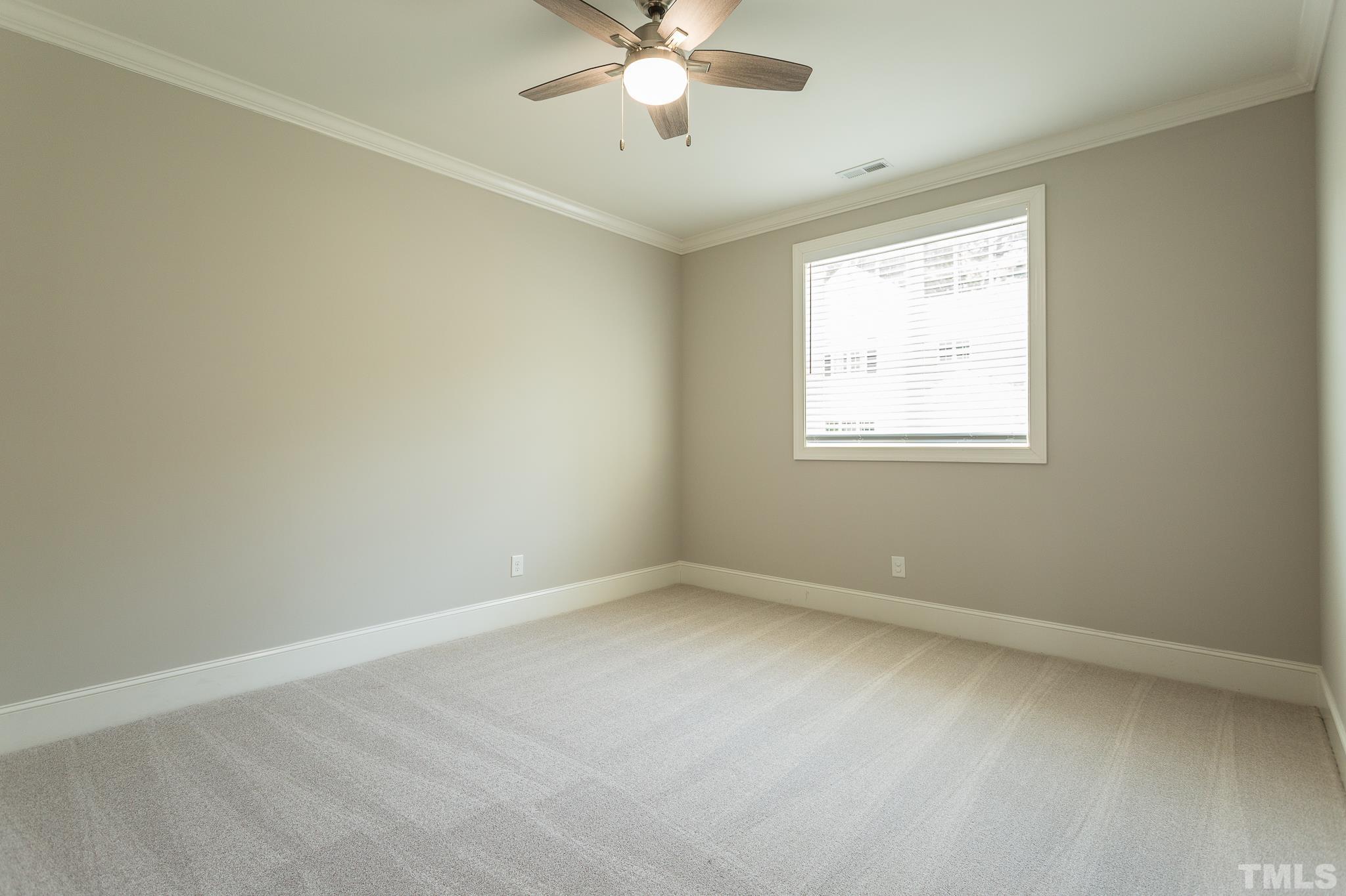 2824 Plumfield Place Raleigh, NC 27607 - Photo 5 of 21 an empty room with a window and a fan