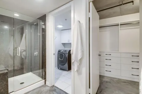 a view of a storage and utility room with washer and dryer