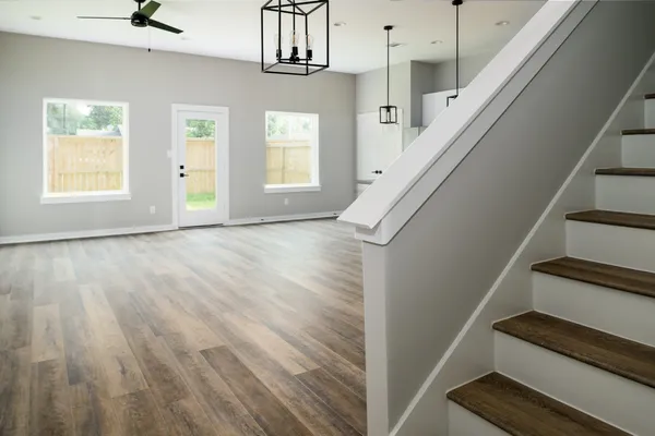 a view of entryway and hall with wooden floor