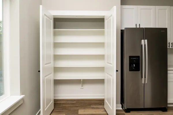 a view of walk in closet with empty racks