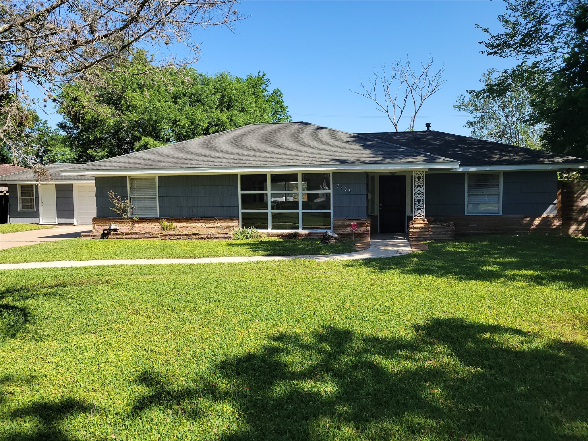 a front view of house with yard and outdoor seating