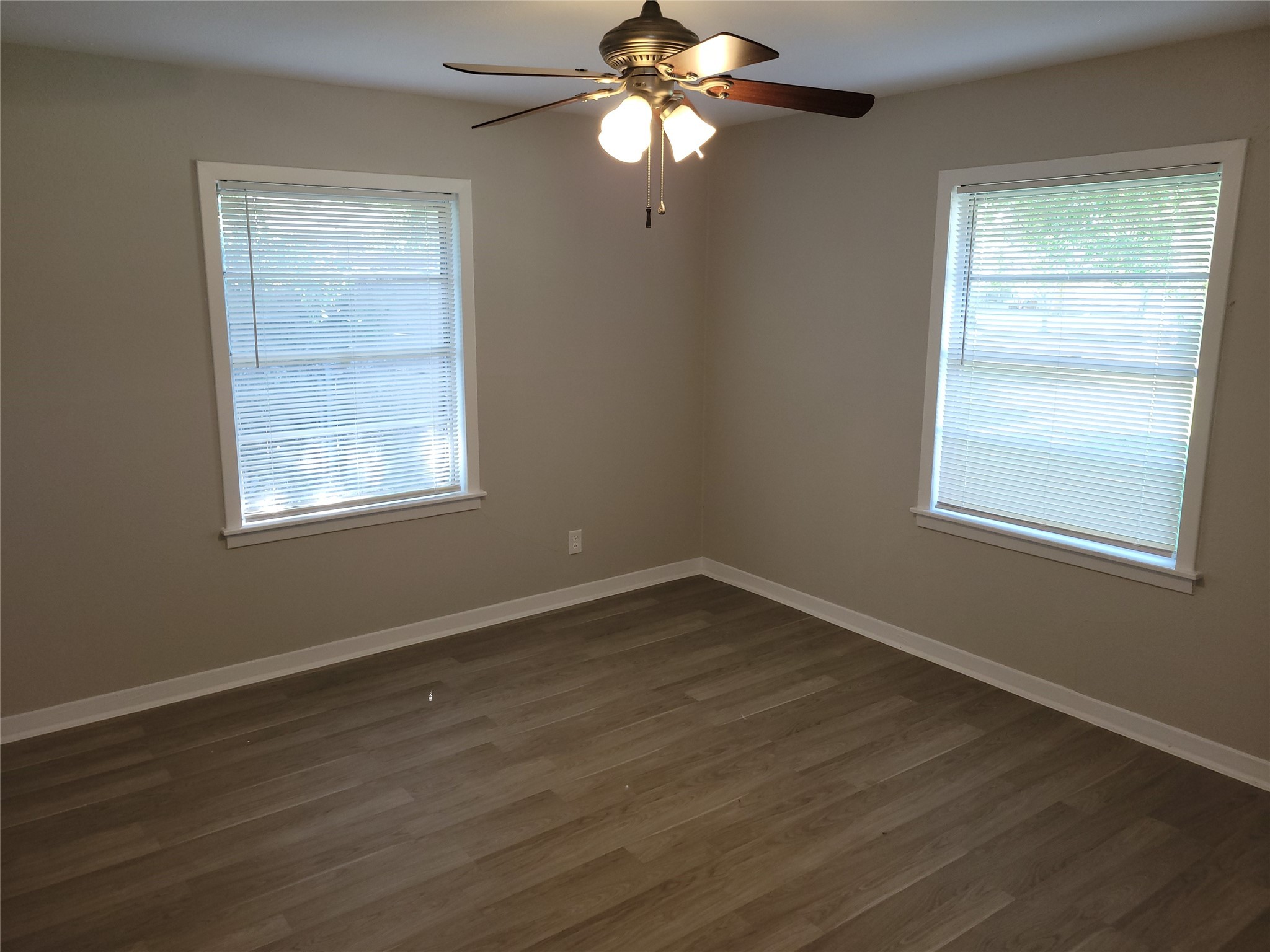 7803 Broadview Drive Houston, TX 77061 - Photo 11 of 13 a view of an empty room with wooden floor and a window