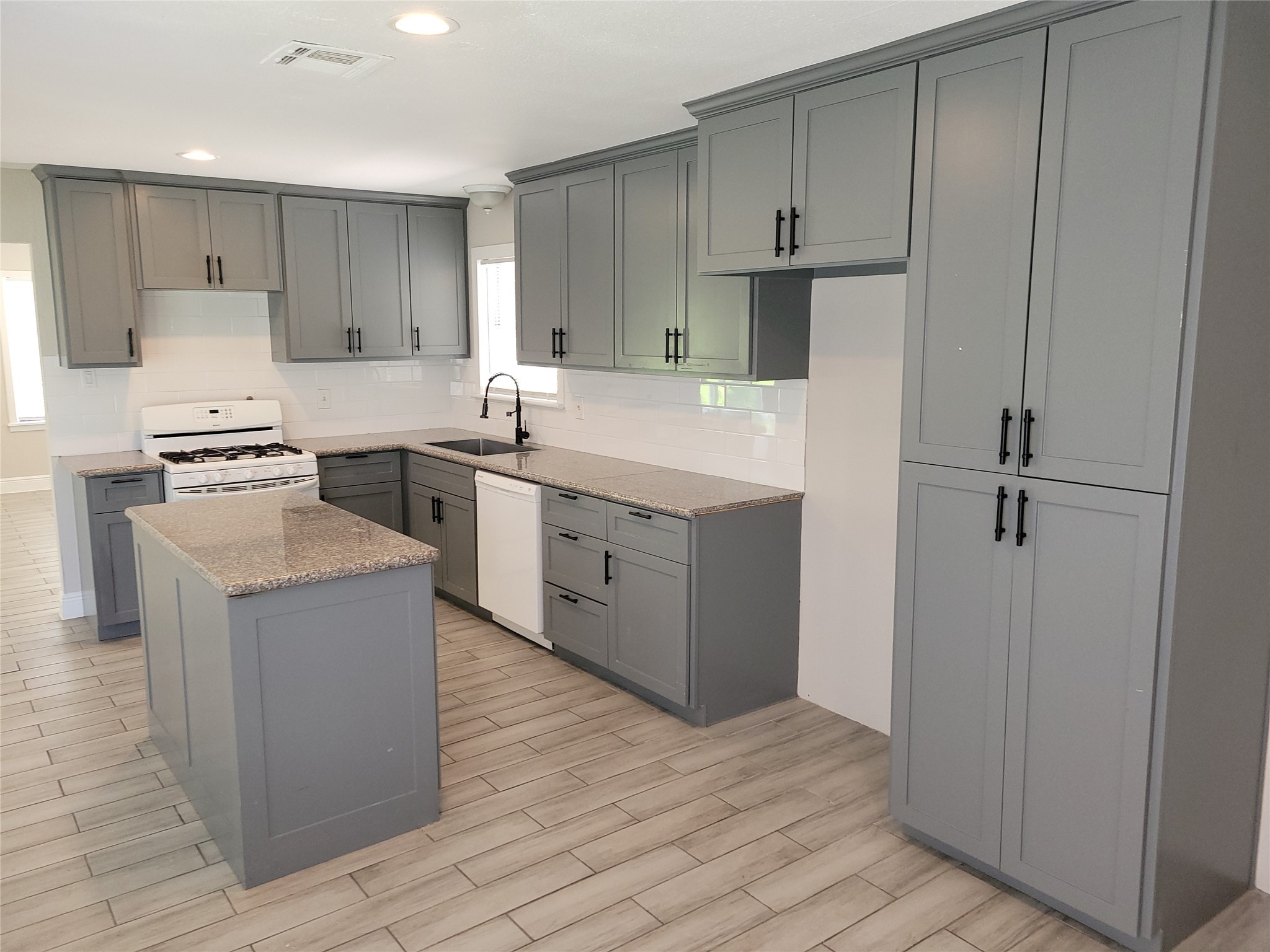 7803 Broadview Drive Houston, TX 77061 - Photo 2 of 13 a kitchen with a stove a refrigerator and a sink