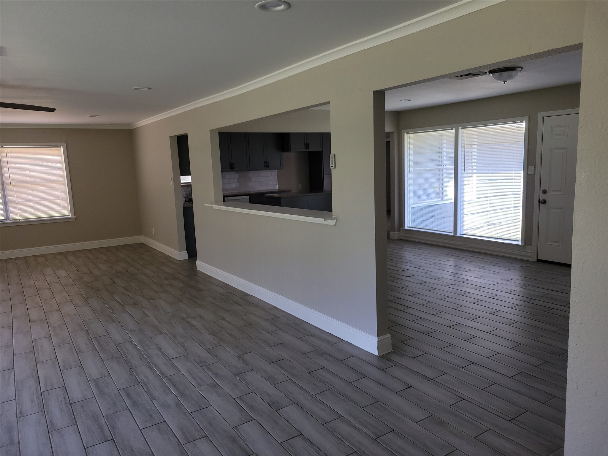 7803 Broadview Drive Houston, TX 77061 - Photo 4 of 13 an empty room with wooden floor and windows