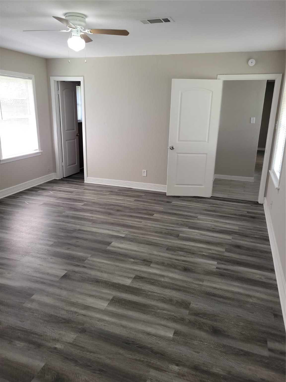 7803 Broadview Drive Houston, TX 77061 - Photo 6 of 13 an empty room with wooden floor and windows