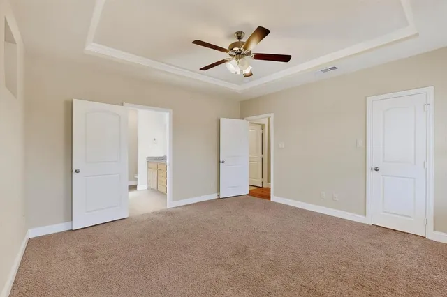 a view of an empty room with a ceiling fan