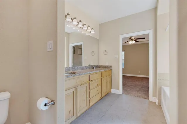 a bathroom with a double vanity sink mirror and shower