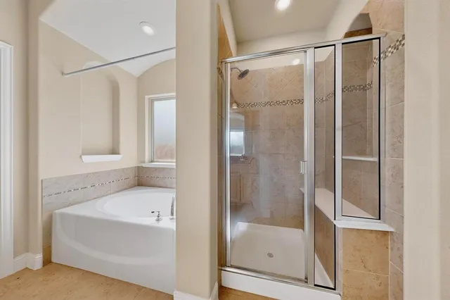 a bathroom with a bathtub and a shower