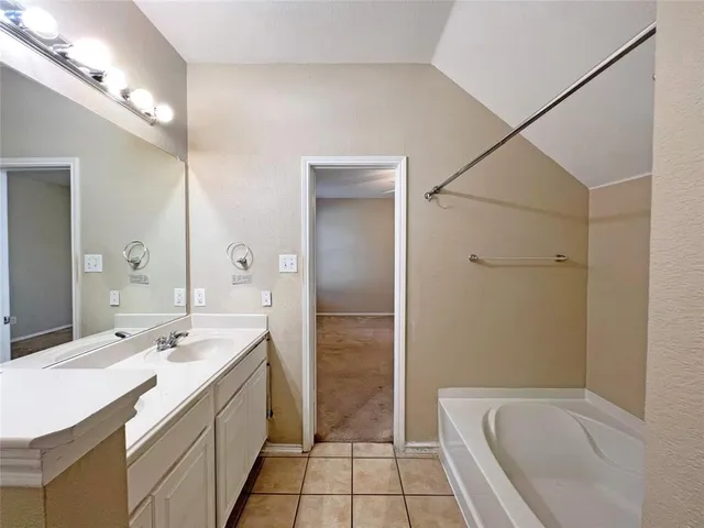 a bathroom with a granite countertop sink a toilet and shower