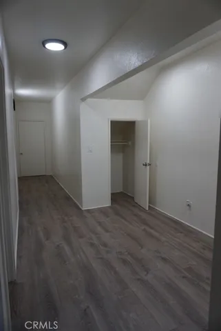 en empty room with wooden floor and closet
