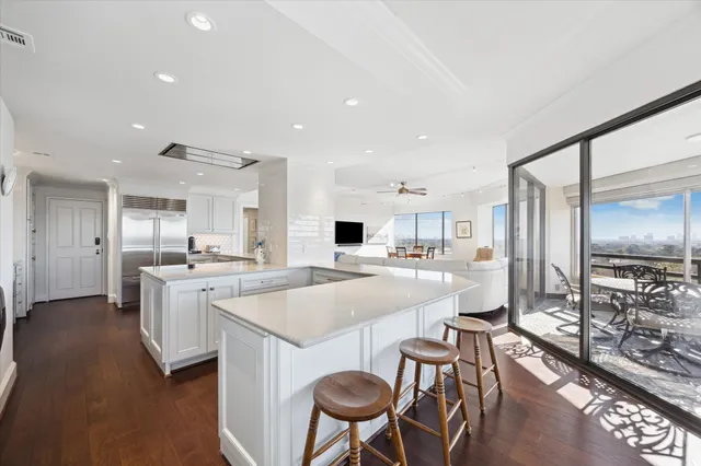 a large kitchen with a table and chairs