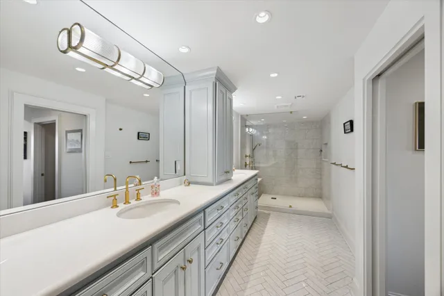 a bathroom with a double vanity sink and mirror with shower