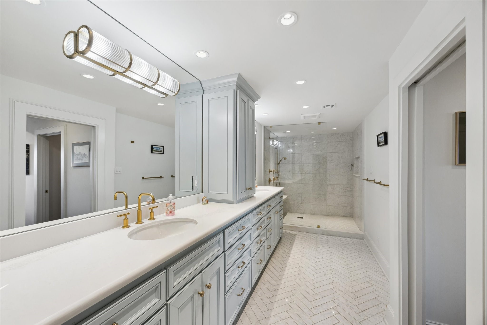 101 Westcott Street, Unit 1202 Houston, TX 77007 - Photo 25 of 38 a bathroom with a double vanity sink and mirror with shower