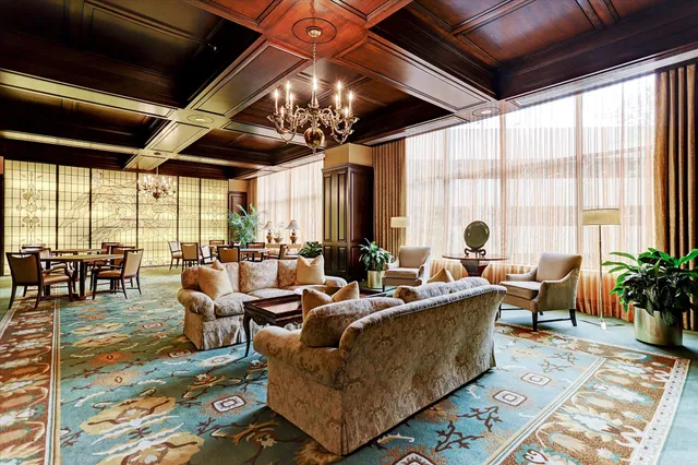 a living room with lots of furniture and a large window