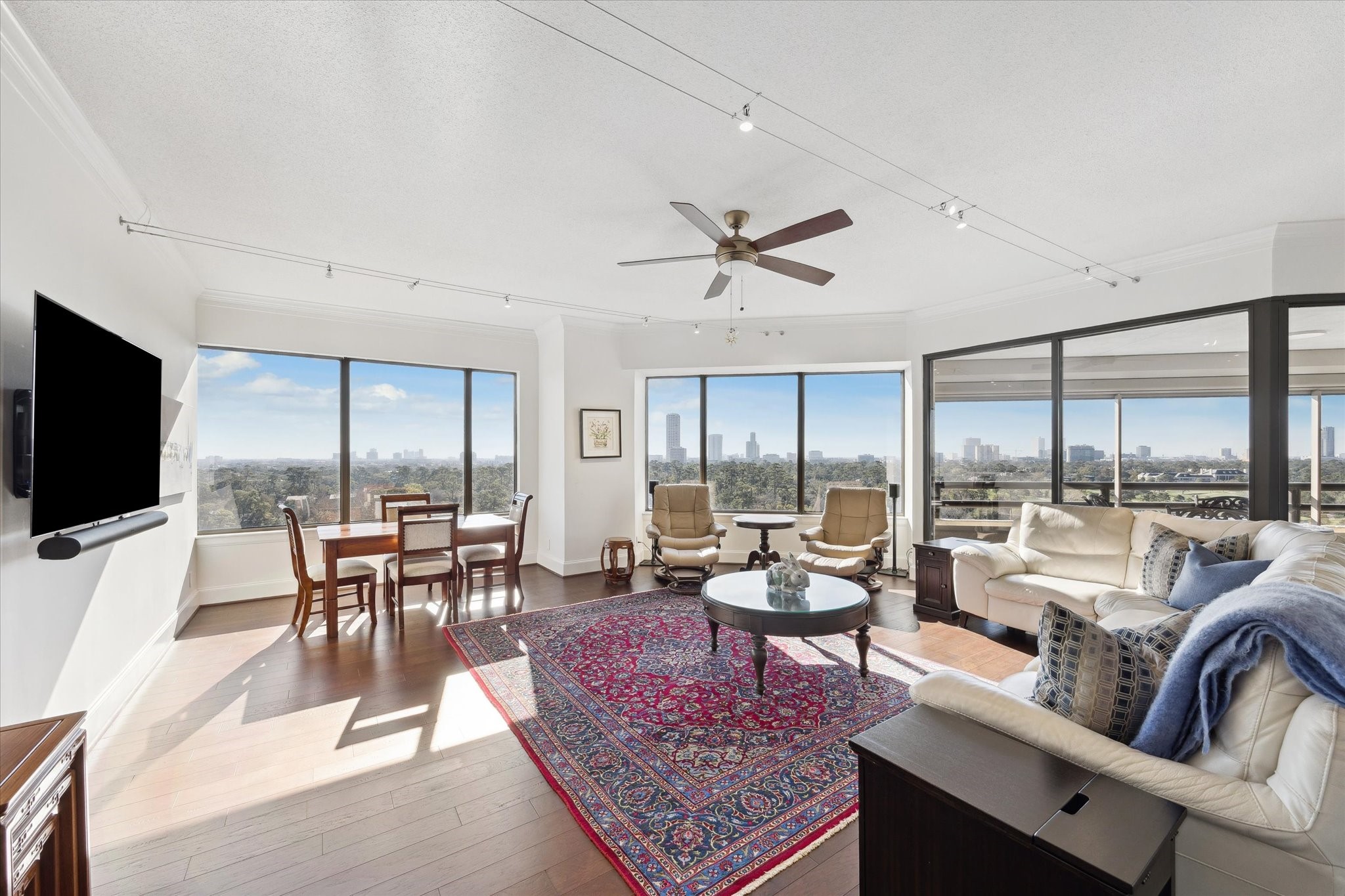 101 Westcott Street, Unit 1202 Houston, TX 77007 - Photo 5 of 38 a living room with furniture a flat screen tv and a large window
