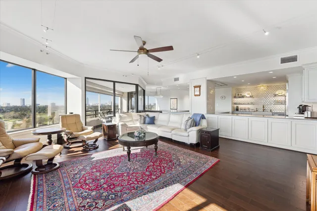 a living room with furniture and a view of kitchen