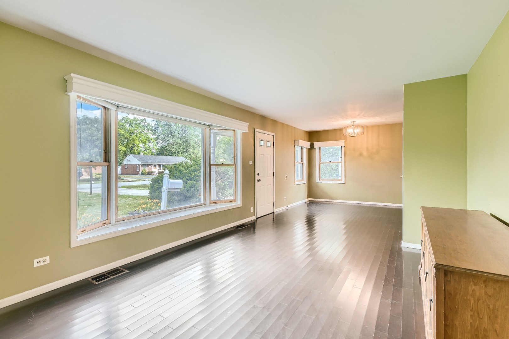 1750 Elliott Street Park Ridge, IL 60068 - Photo 4 of 22 a view of an empty room with wooden floor and a window