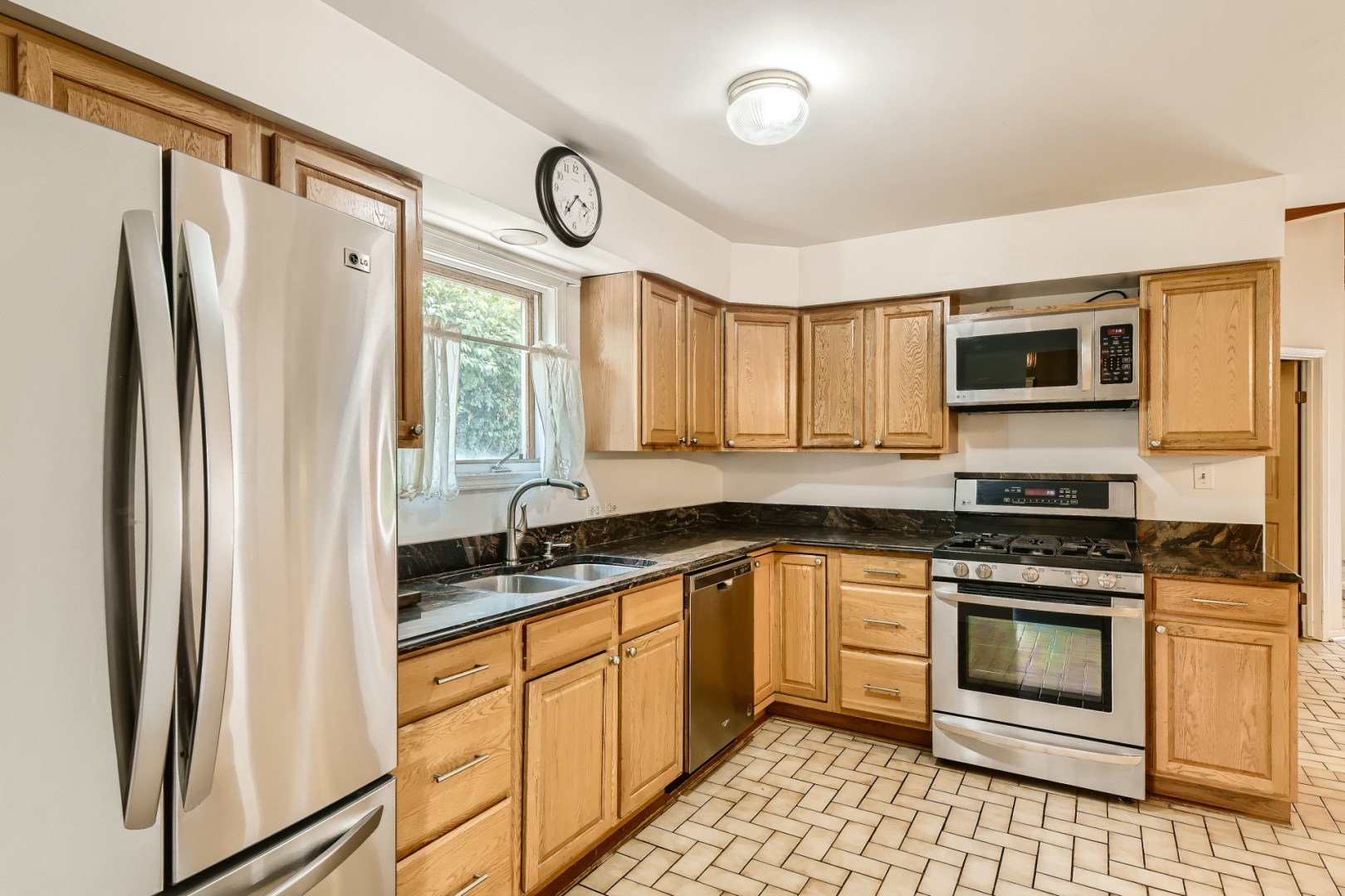 1750 Elliott Street Park Ridge, IL 60068 - Photo 6 of 22 a kitchen with granite countertop a refrigerator stove top oven and sink
