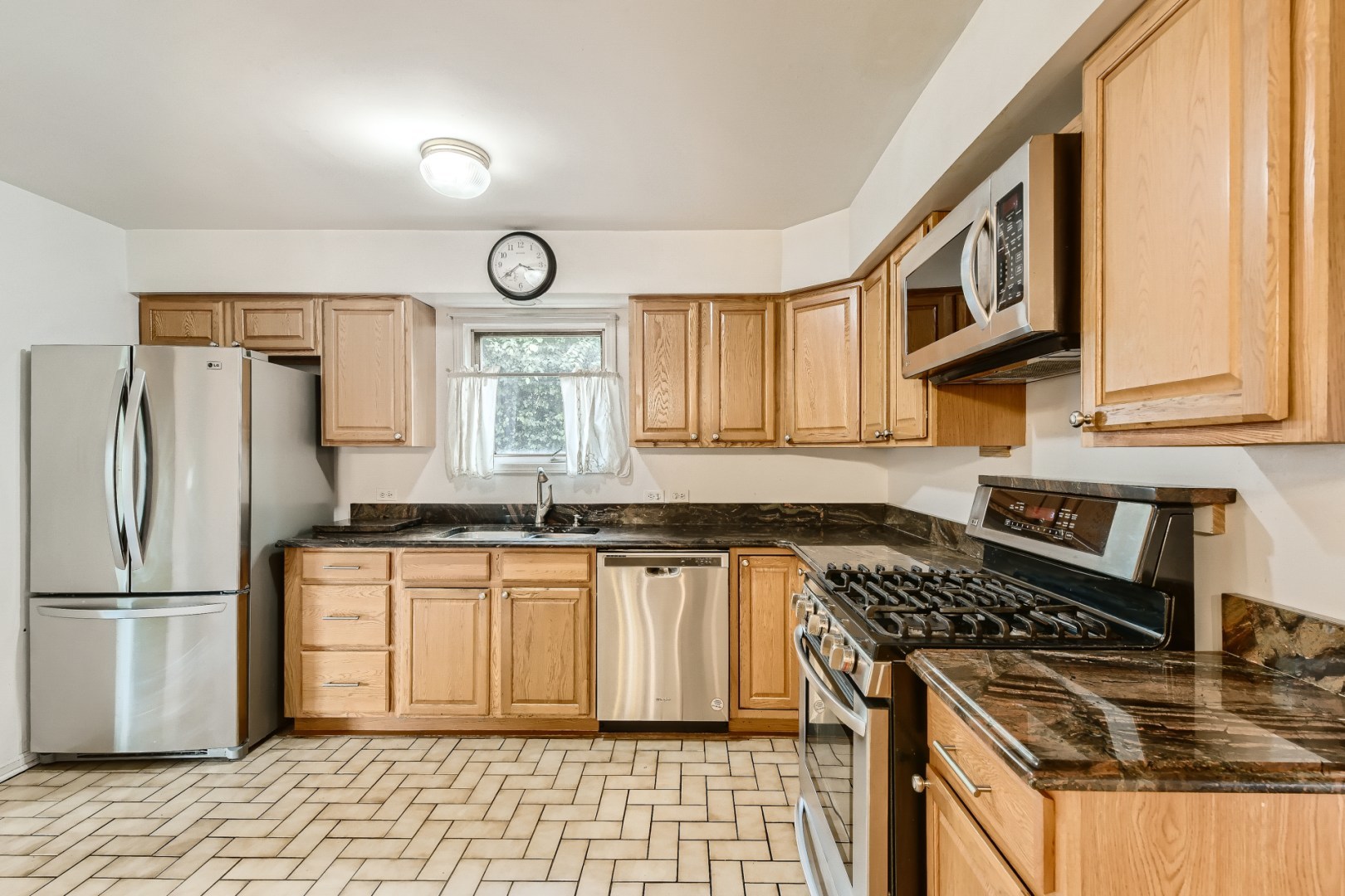 1750 Elliott Street Park Ridge, IL 60068 - Photo 7 of 22 a kitchen with stainless steel appliances granite countertop a stove a sink and a refrigerator