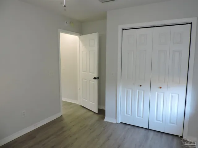 a view of a room with wooden floor