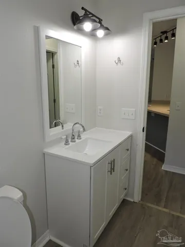 a bathroom with a sink a toilet and mirror