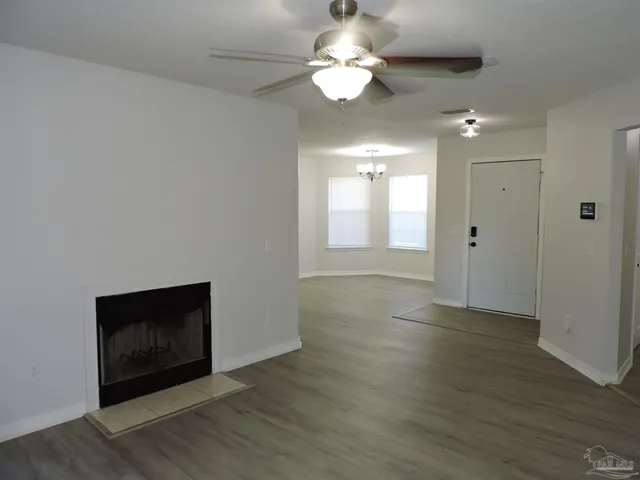 a view of an empty room with a bathroom and a window