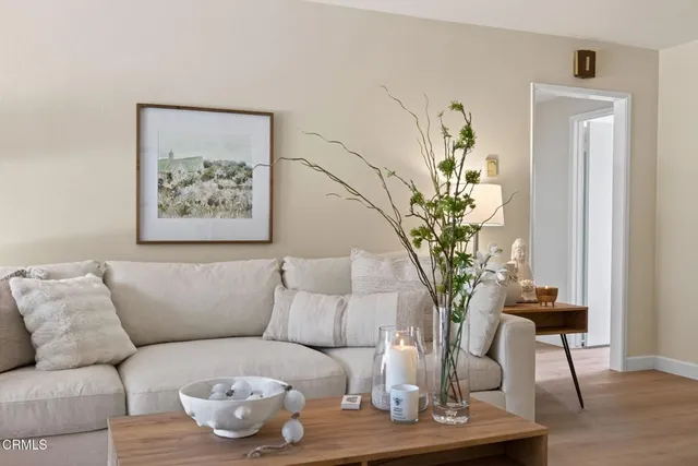 a living room with furniture a large window and a fireplace