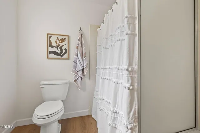 a bathroom with a granite countertop sink and a toilet
