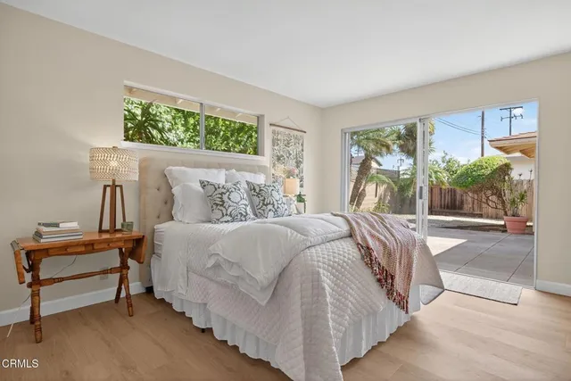 a view of a house with a yard and large tree