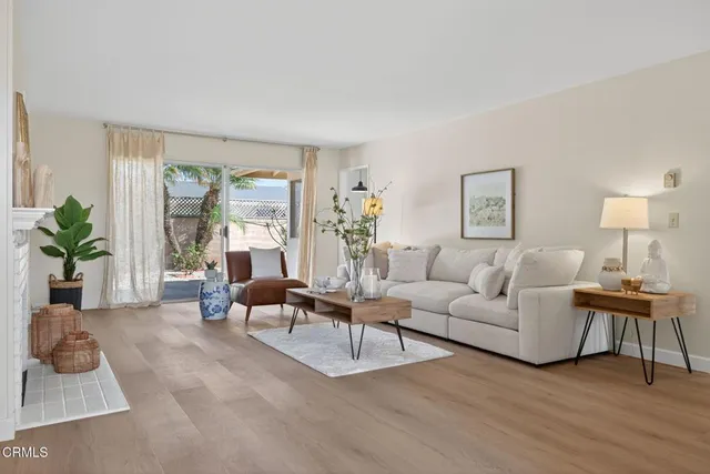 a living room with furniture large window and a fireplace